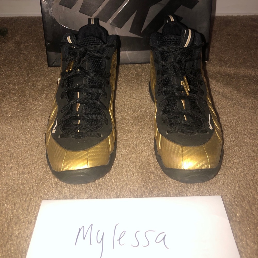 Metallic gold and black Nike foams